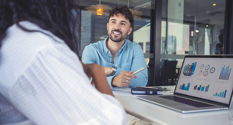 Person working with a client discussing consulting pricing models on a laptop