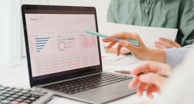 Closeup of business people discussing project plan risks on a computer 