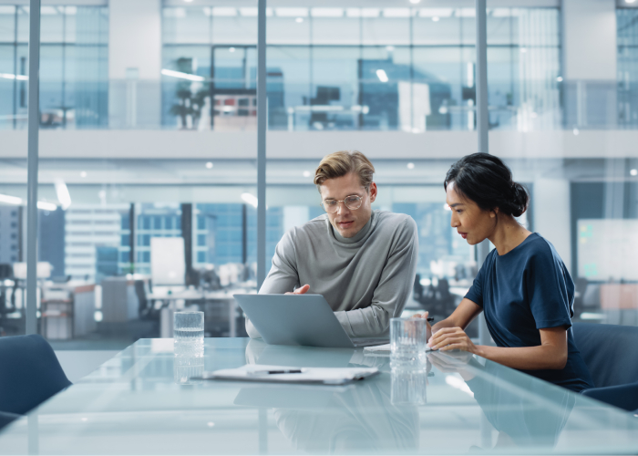 A team of two consultants discussing consulting pricing models