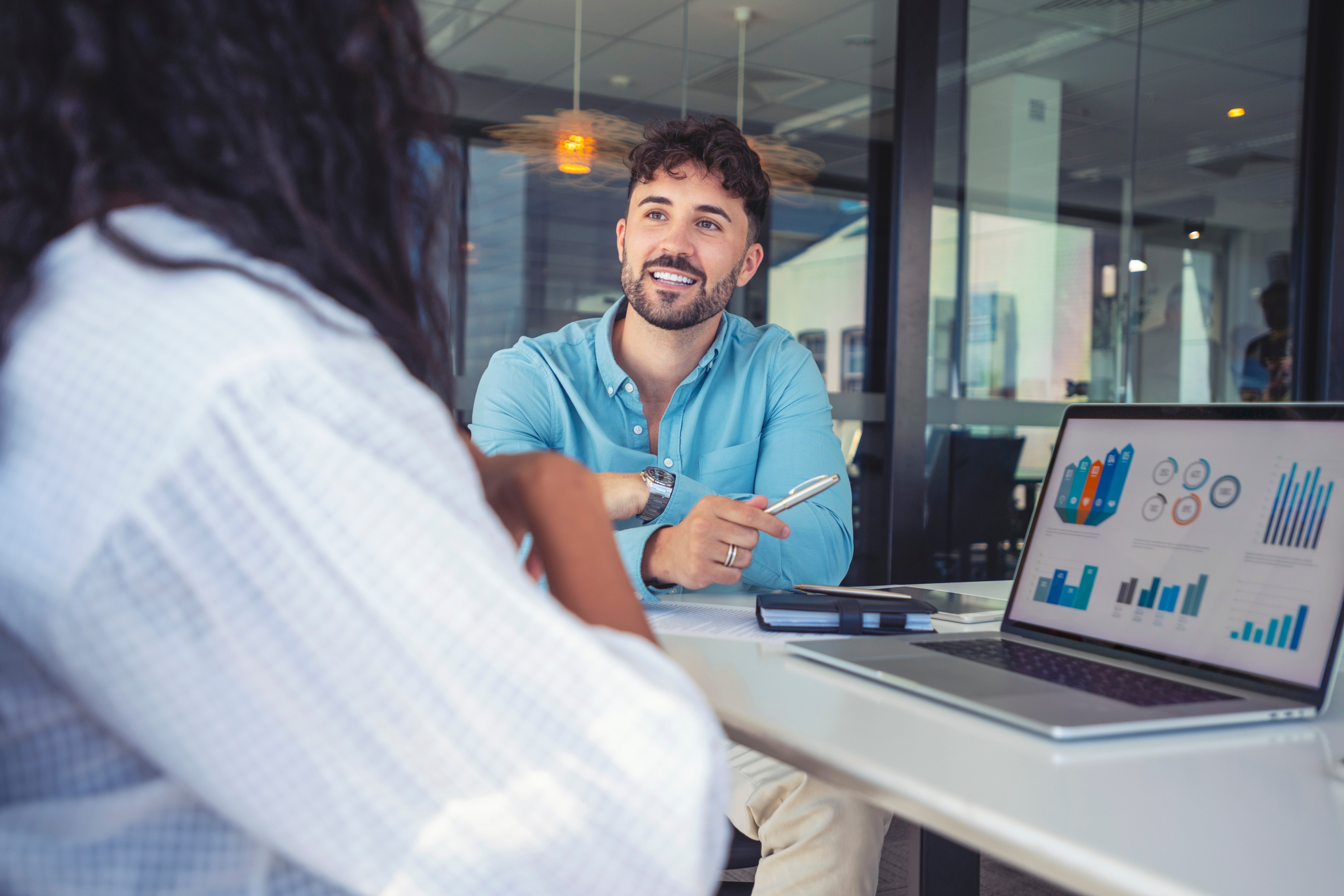 Business professional reviewing data on a laptop