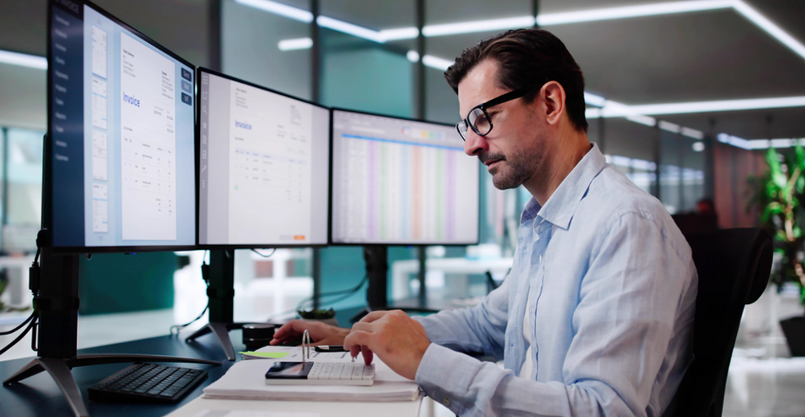 accountant reviewing invoices at his desk