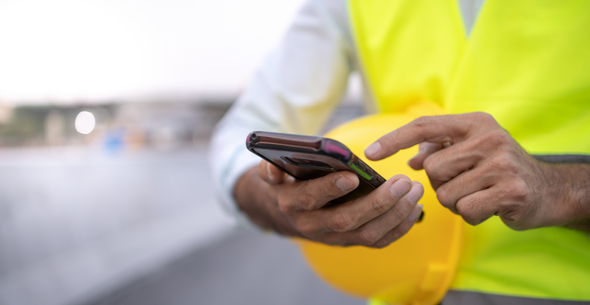 close up of architect using mobile app during site visit