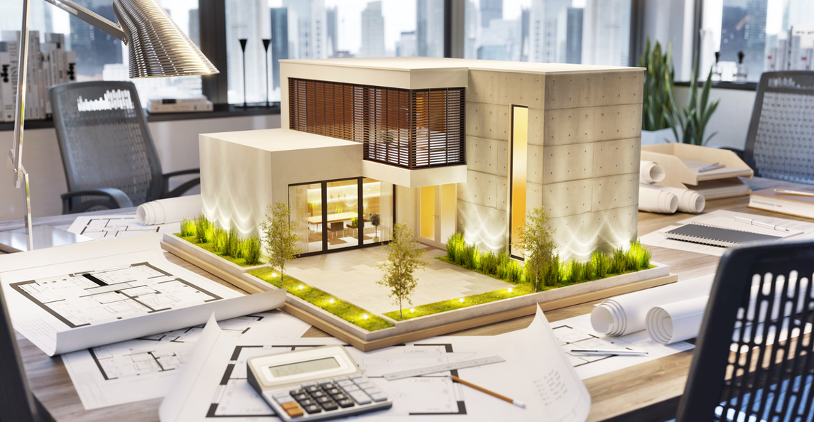 Architecture firm desk with building model, blueprints and plans