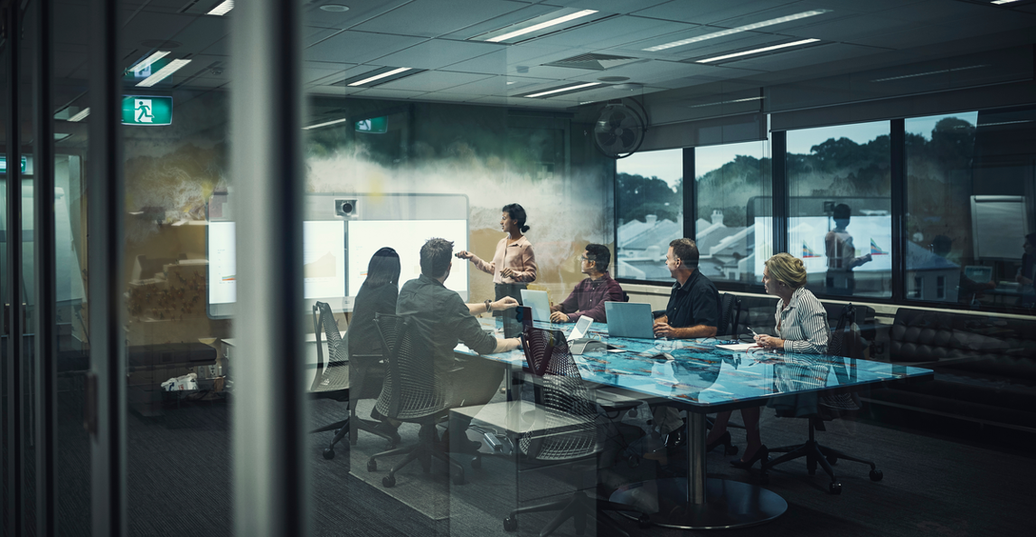 A diverse business team attending a presentation in a modern boardroom