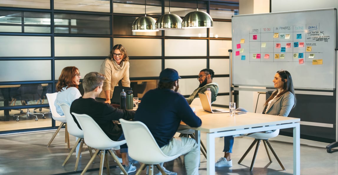 Professional presenting to colleagues in a bright modern office