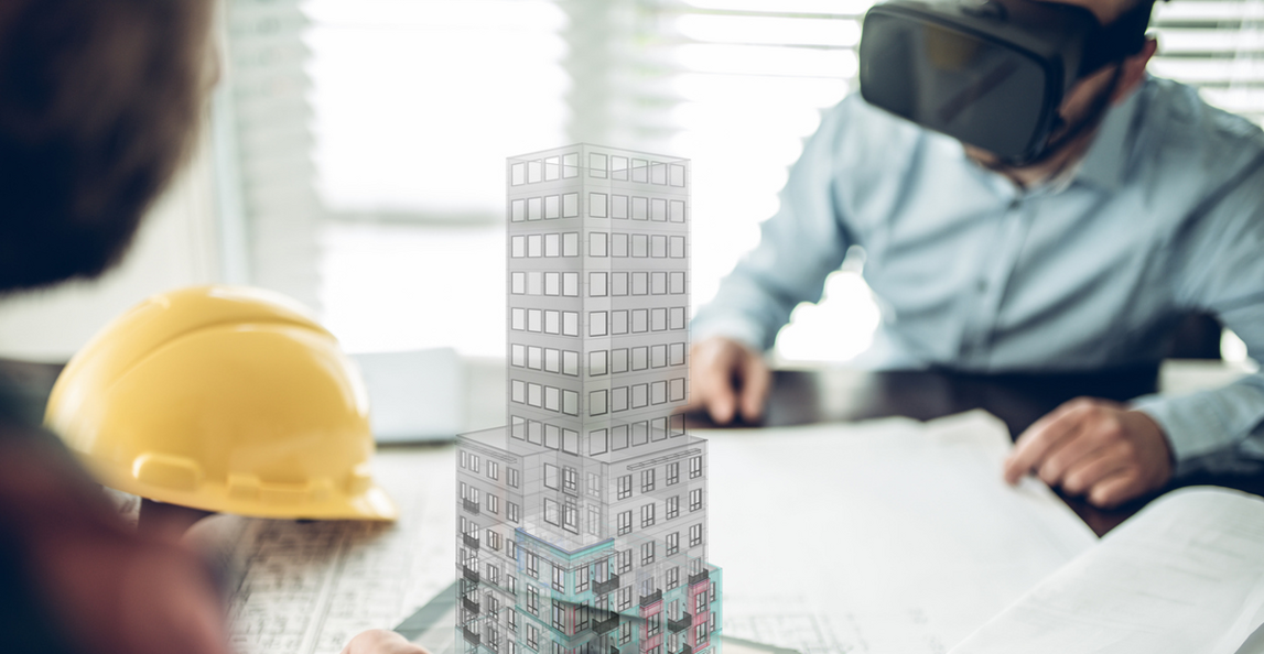 Construction professionals using VR headset and holographic building model to visualize automation in construction