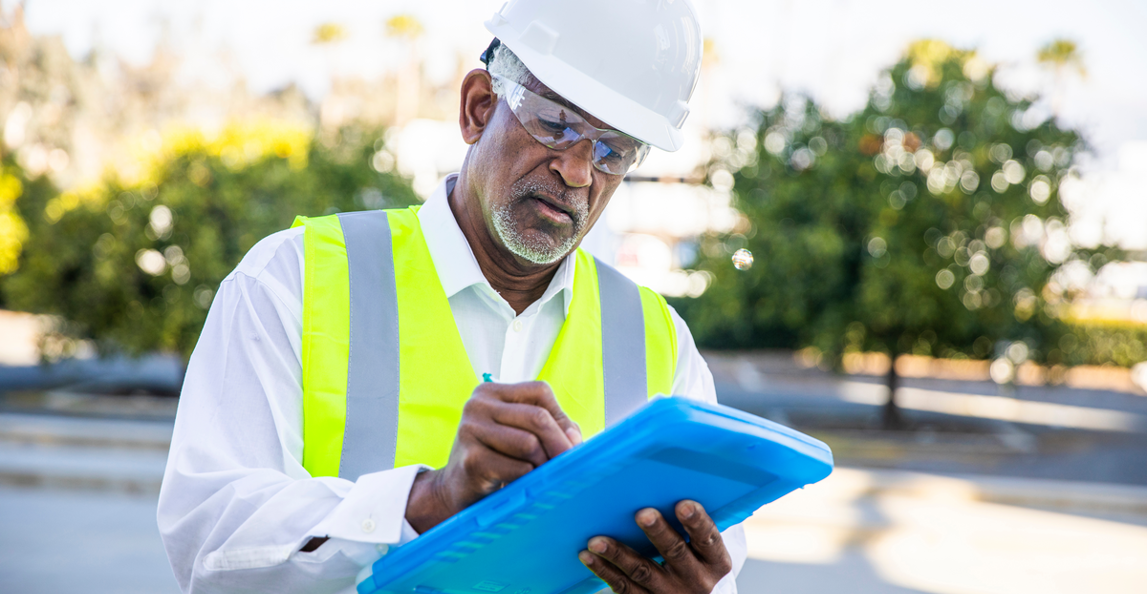 construction manager taking notes on site visit