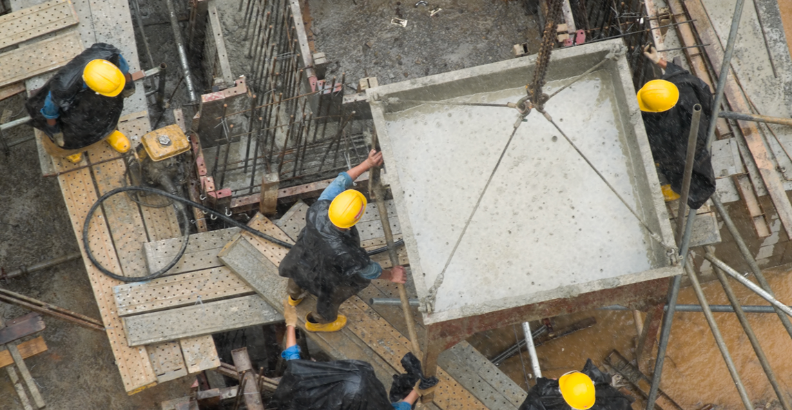 construction workers working at height on a new building