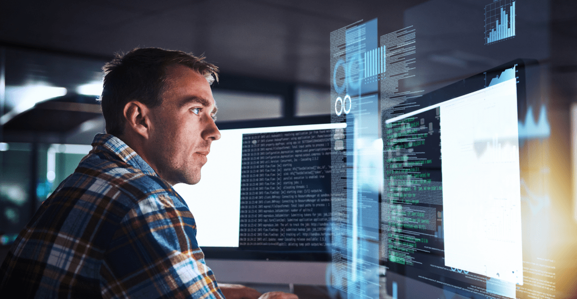 Consultant working on multiple screens