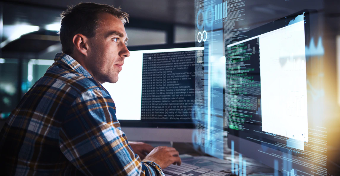 data-analyst-reviewing-code-and-analytics-dashboards-on-a-computer