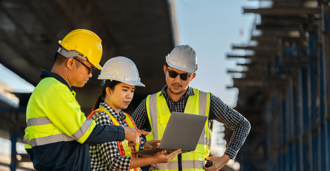 Construction team reviewing project information on a laptop
