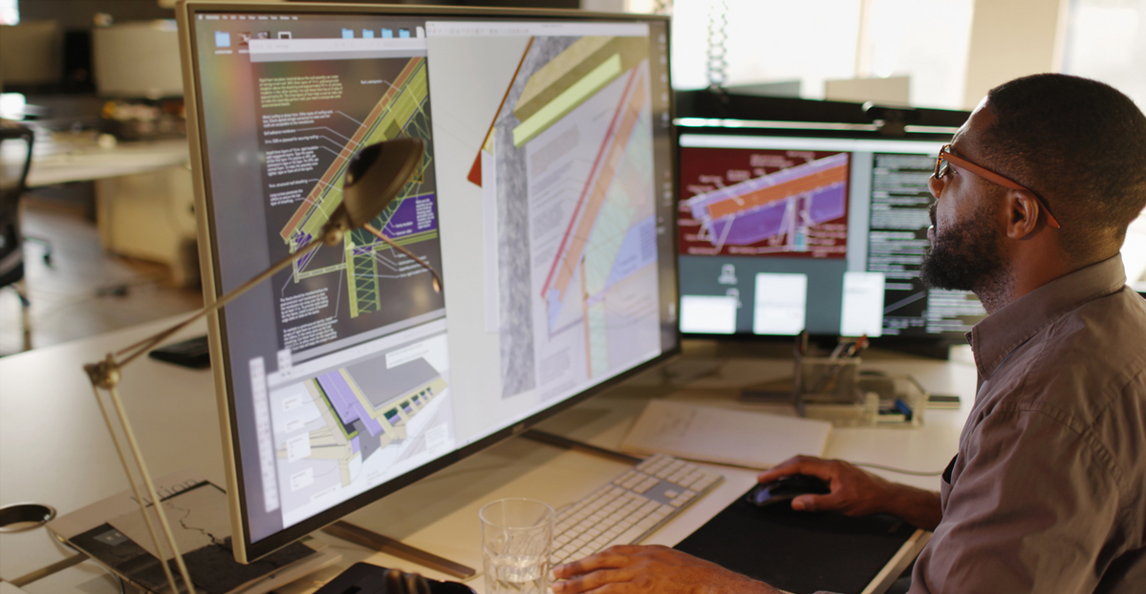 Architecture and engineering professional working on BIM software at a desk