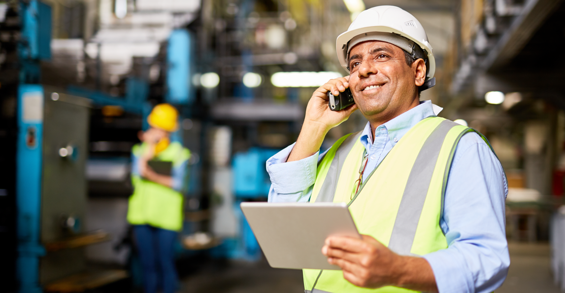 manager taking a call on the factory floor