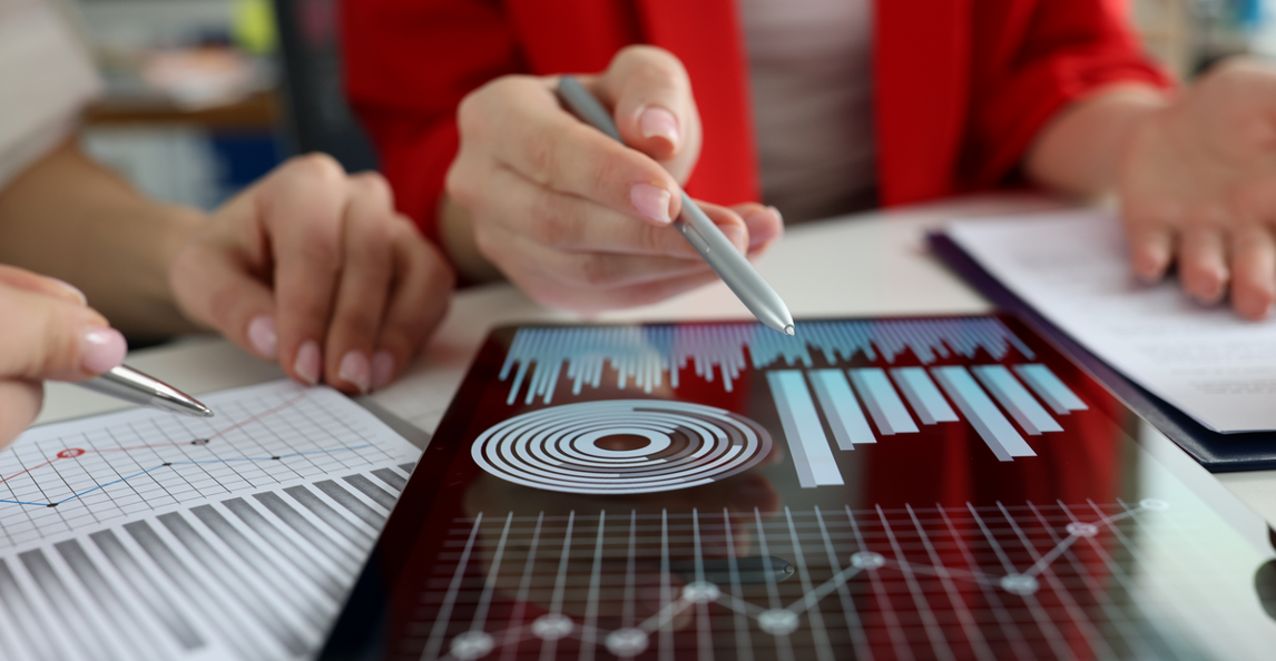 Professionals reviewing project portfolio data and charts on a tablet