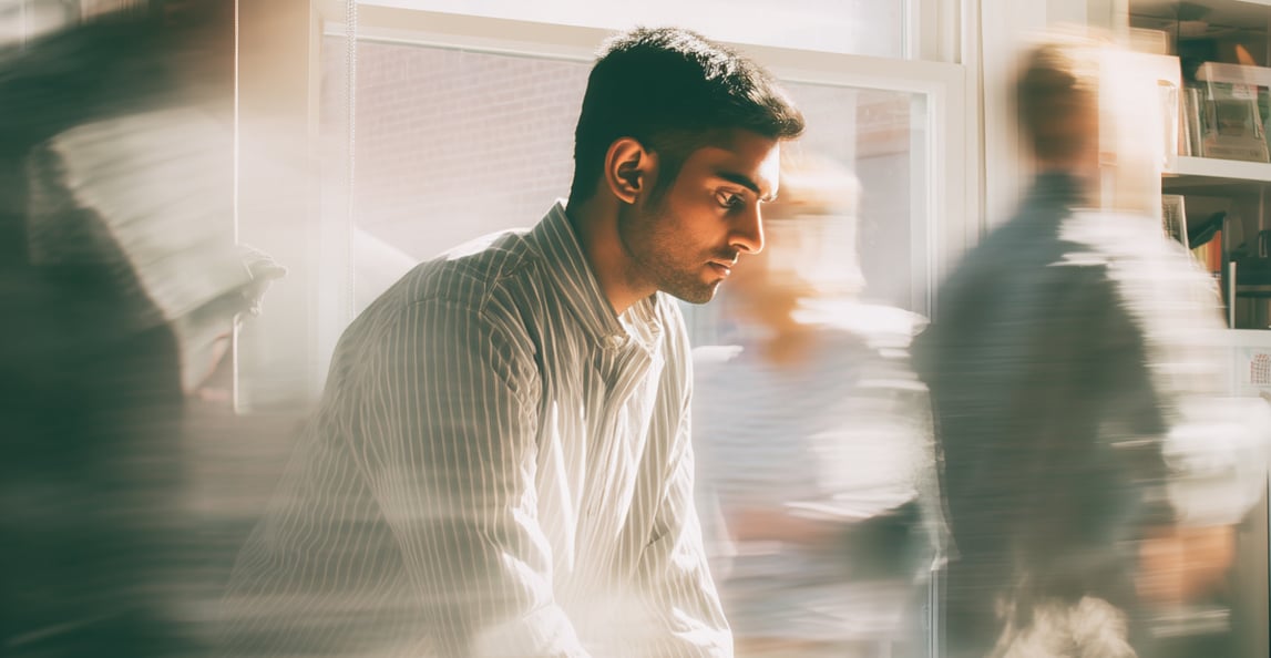 Professionals working in a busy sunlit office environment representing small and midsize business operations