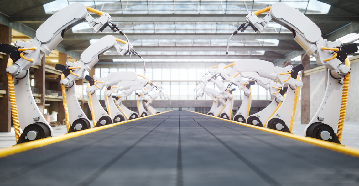 Robotic arms lining an automated conveyor belt in a modern manufacturing factory