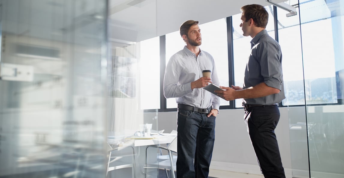 two professionals discussing a project in an office