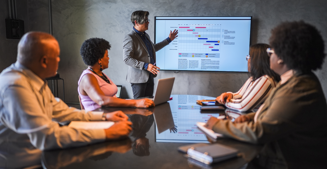 Professional services team reviewing a project schedule on a screen