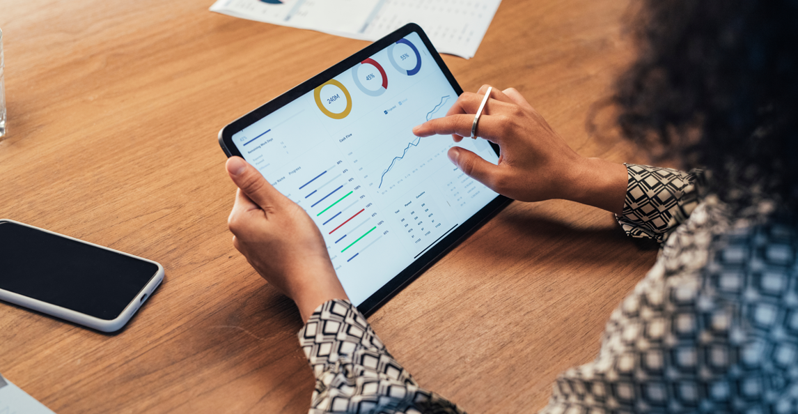Architecture firm professional reviewing profit and cash flow metrics on a tablet