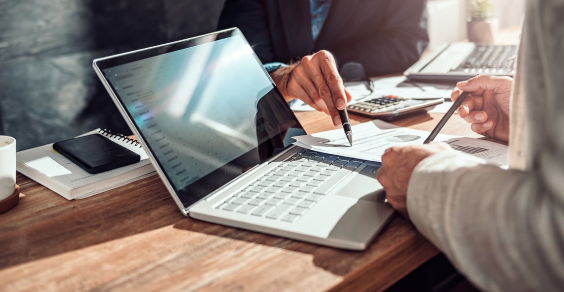 clouse up of two people working on financial reporting data