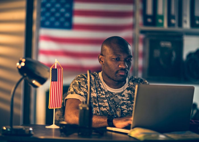 American soldier using a laptop