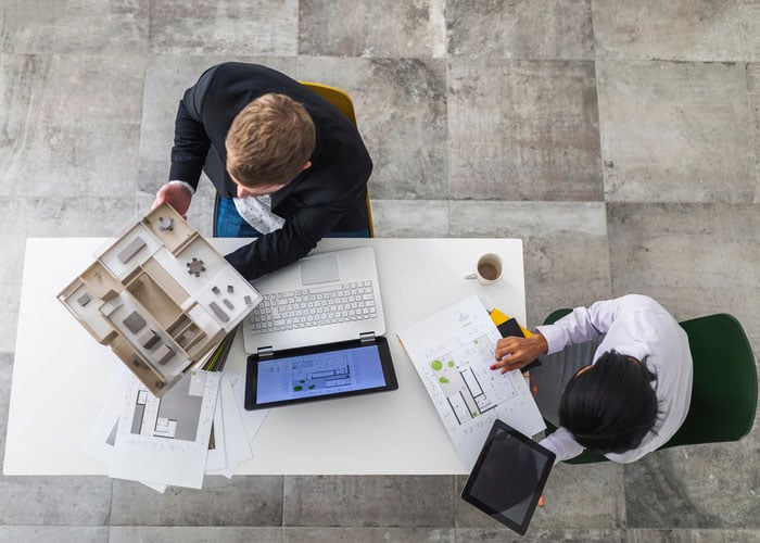 Aerial view of two architects discussing a project