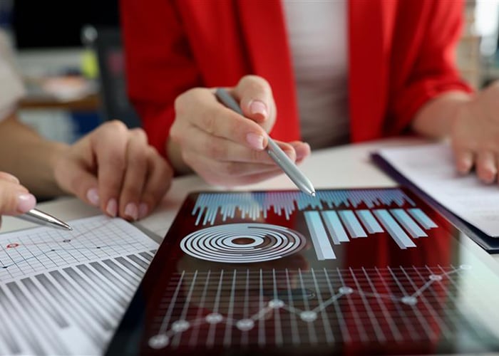 Professional services workers reviewing data trends and results