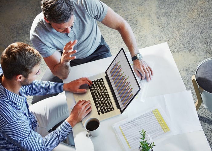 Business professional using technology to chart company growth and performance