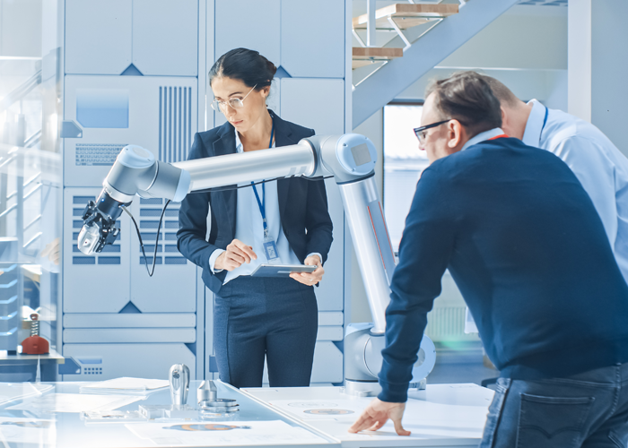 Team reviewing robotics equipment in a technology lab