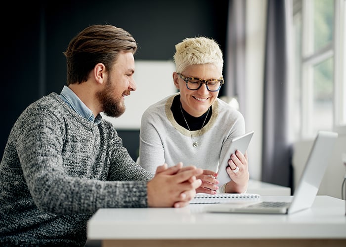 Two employee discussing in the office with laptop