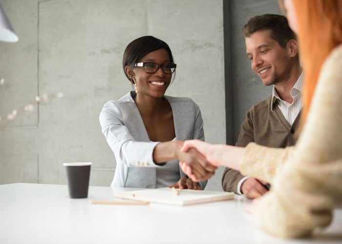 Business Professionals Closing Deal with Handshake at Corporate Client Meeting