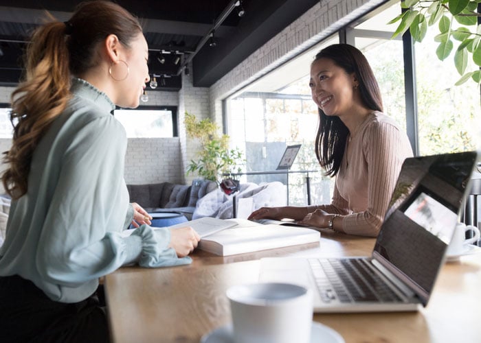 two coworkers discussing in the office