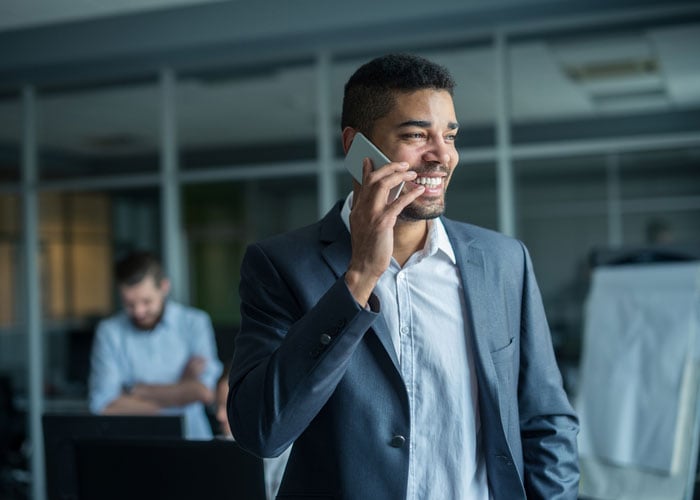 Talking on a cell phone with a client