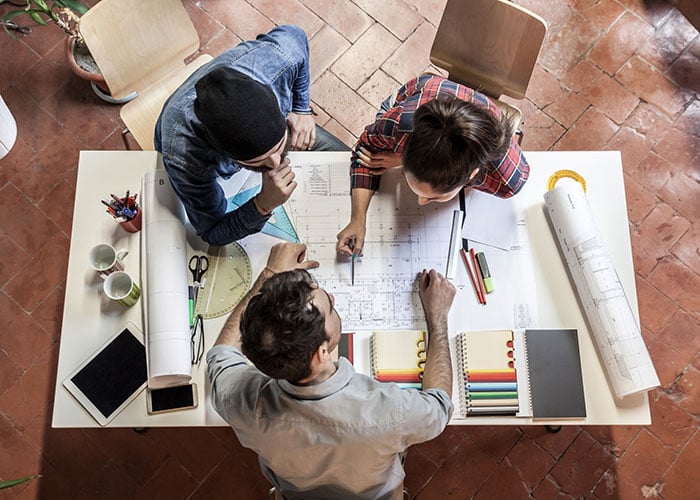Three young employee working on a project