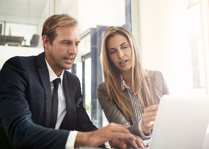 Two people looking at monitor