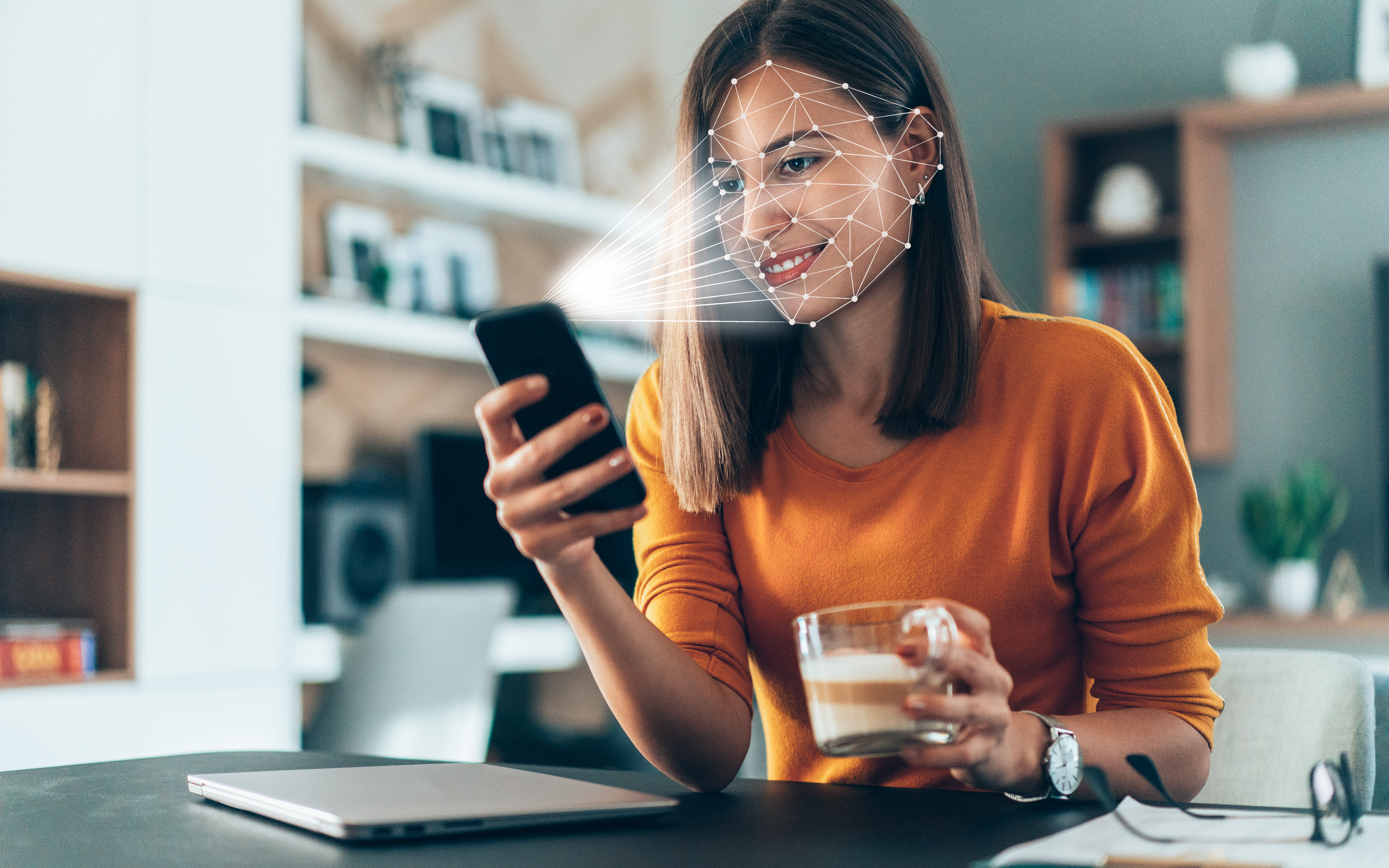 Woman authenticating with facial recognition on a smartphone
