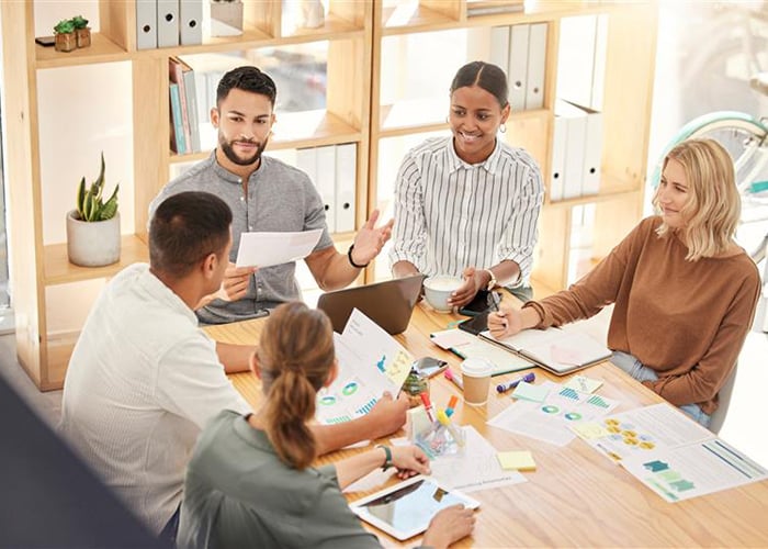 Diverse Workforce Team Collaborating on Resource Planning and Optimization Strategies in Office Meeting
