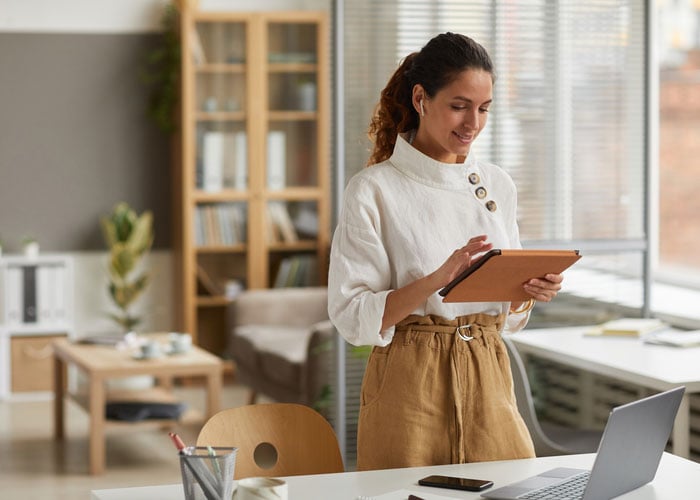 Business Professional Reviewing Project Information on Tablet