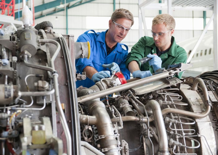 Workers in aerospace and defense manufacturing facility
