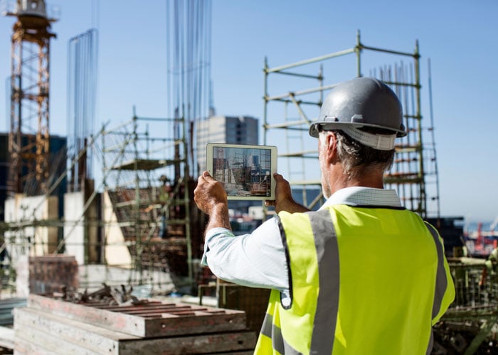 Construction worker using Ipad