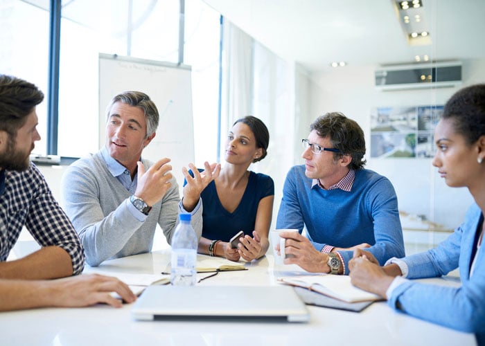 Business people brainstorming around a conference table