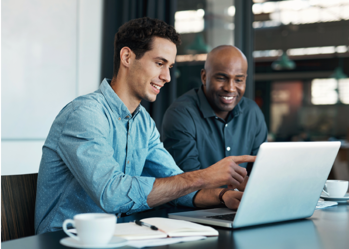 Two young employee discussing with laptop