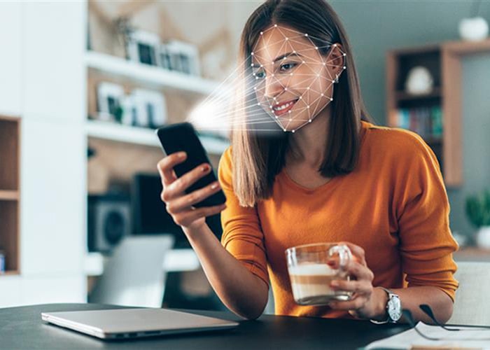 Person using facial recognition on a smartphone
