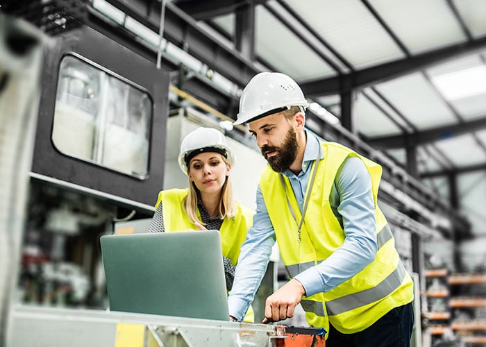 An industrial man and woman engineer with laptop
