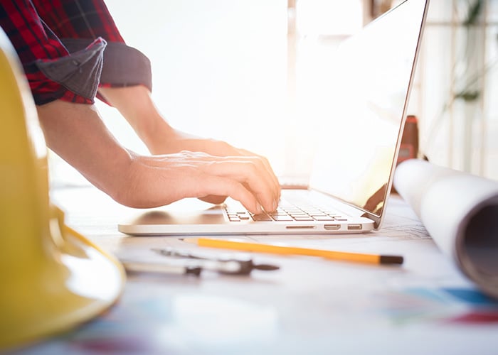 Architect typing on a laptop