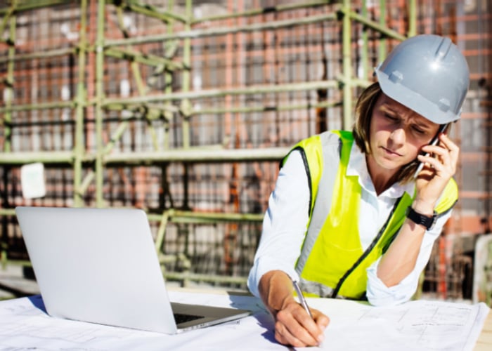 architect using mobile phone while working on site