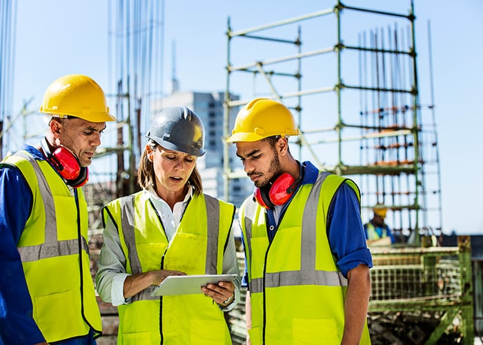 Architects using a digital tablet at construction site