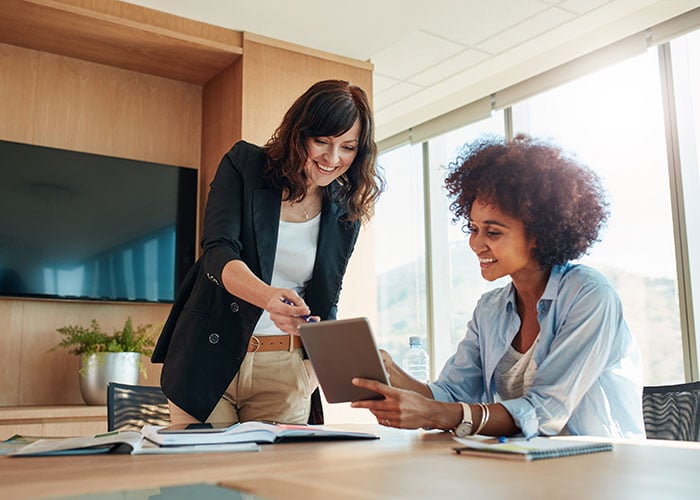 Business professionals having a meeting in an office using a tablet
