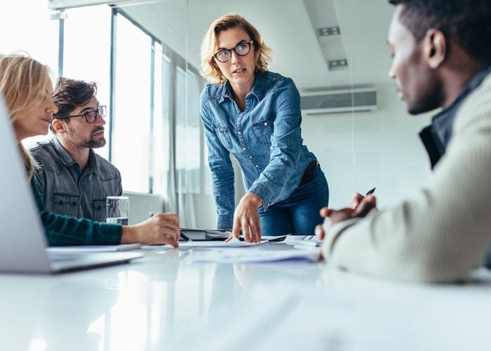 Businesswoman standing and leading business presentation