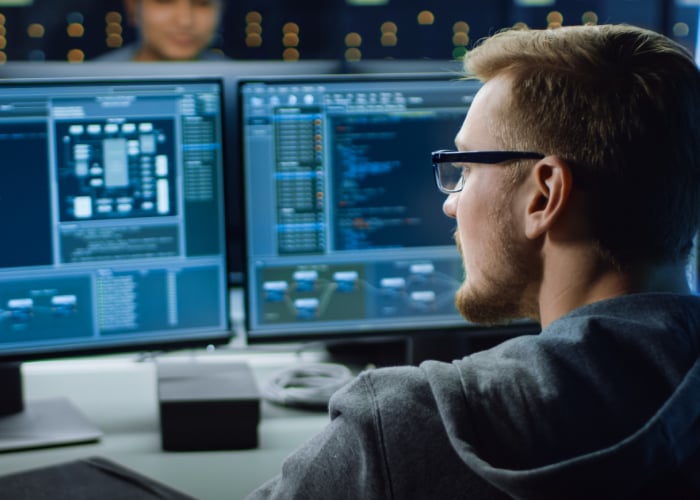 Employee working with multiple screen